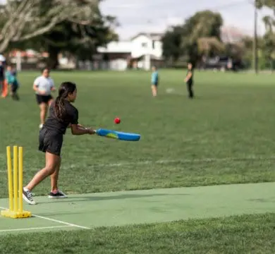 Young woman plays cricket