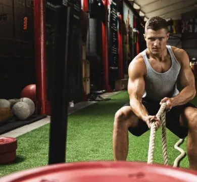 Crossfit sled push man pushing weights