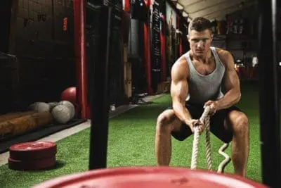 Crossfit sled push man pushing weights