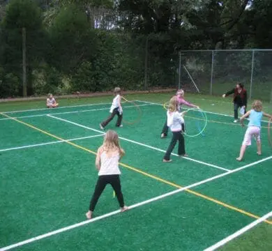 Kids playing at high-quality synthetic grass for outdoor