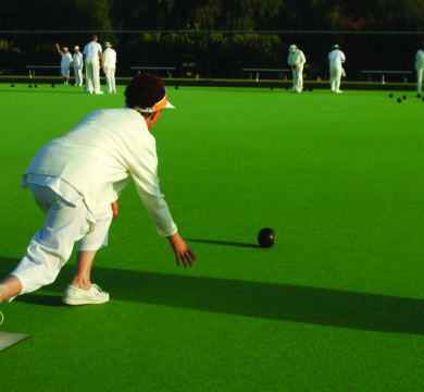 Woman plays bowling on Green Artificial Turf