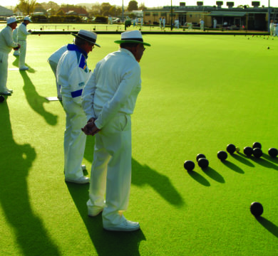 Old men plays bowling on Green Artificial Turf