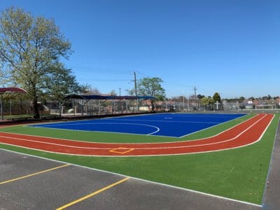 Holy Name Primary School asked TigerTurf to upgrade a tired, grey asphalt area with a bright, colourful and functional TigerPlay