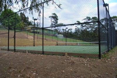 Turning a steep hill paddock into a tennis court