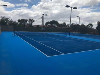 Dashing two-tone blue TigerTurf Elite tennis courts at Hadfield Tennis Club