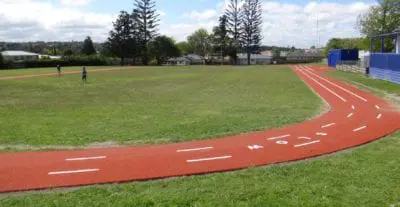 Another View of Track field with Red TigerTurf Artifical Grass and people playing