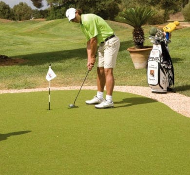 A man holding a Golf Club on a Golf Field